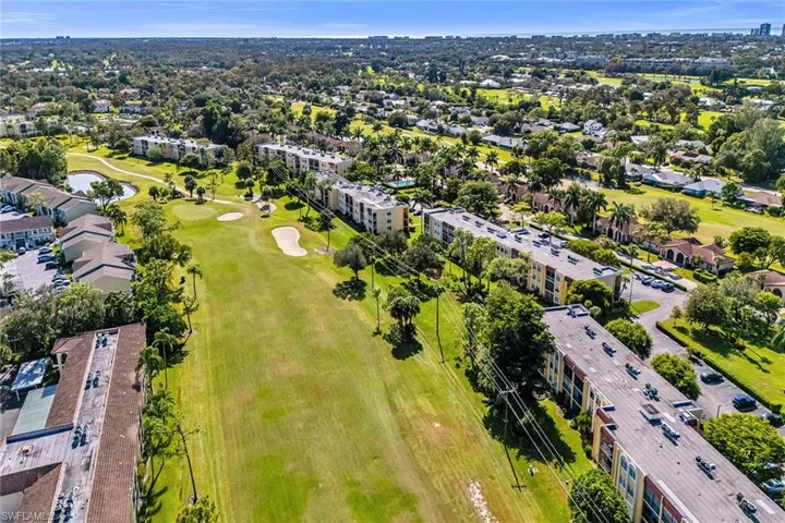 View of property location featuring a local golf course and nearby suburban area