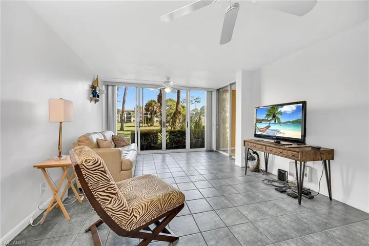 Living area with expansive windows and tile patterned flooring