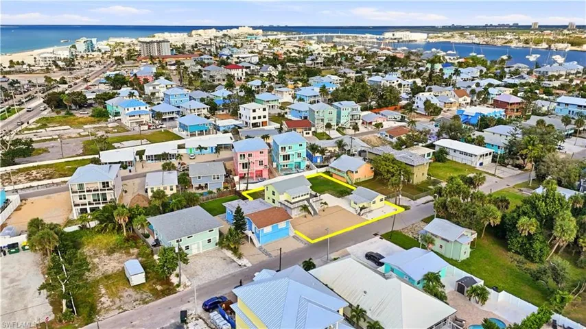 Aerial view of residential area featuring a nearby body of water - Virtually Edited Image