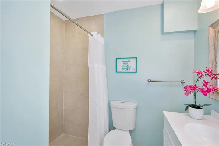 Bathroom with a stall shower and vanity - Virtually Edited Image