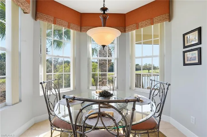 Dining space featuring light tile patterned flooring and plenty of natural light