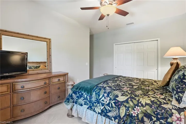 Bedroom featuring a ceiling fan and a closet