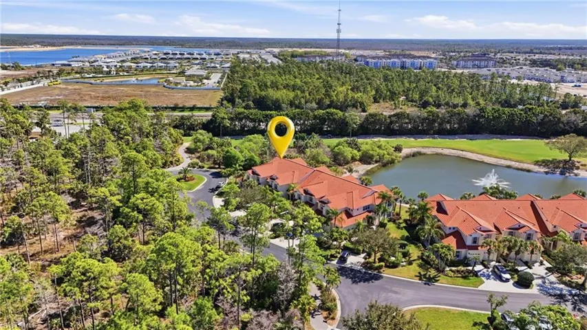 Aerial view of residential area with a large body of water and a golf course