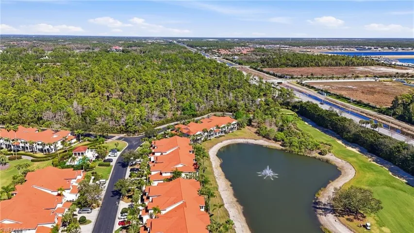Aerial view of property's location with a large body of water and nearby suburban area