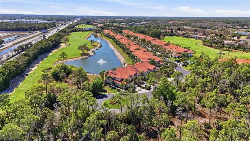 Aerial perspective of suburban area with a local golf course and a large body of water