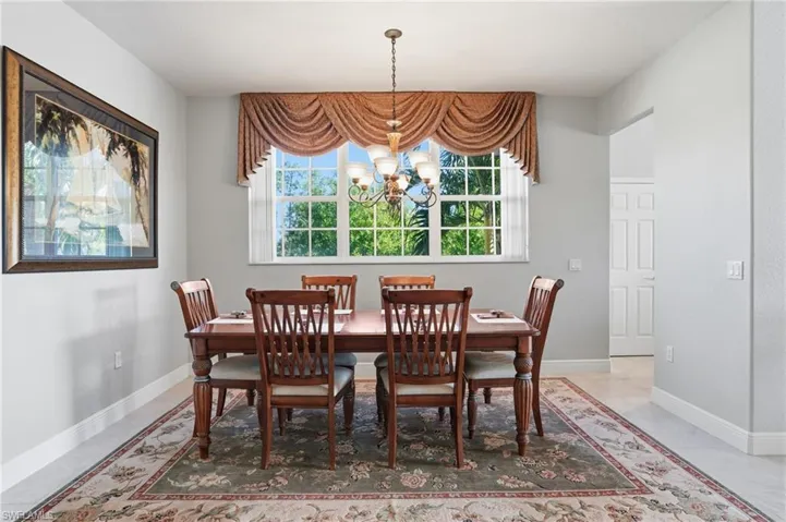 Dining space with suspended lighting and baseboards