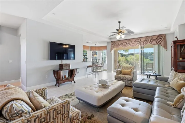 Tiled living area with ceiling fan and recessed lighting