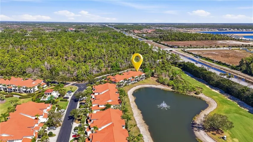 View of property location featuring a nearby body of water and nearby suburban area