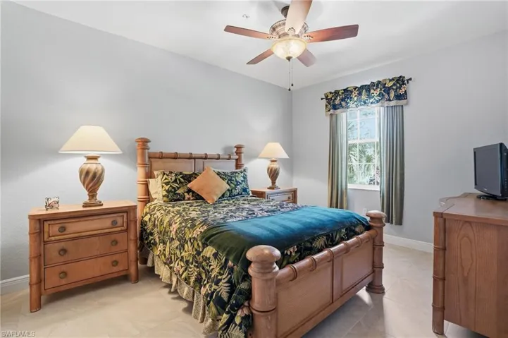 Bedroom with a ceiling fan and light tile patterned floors