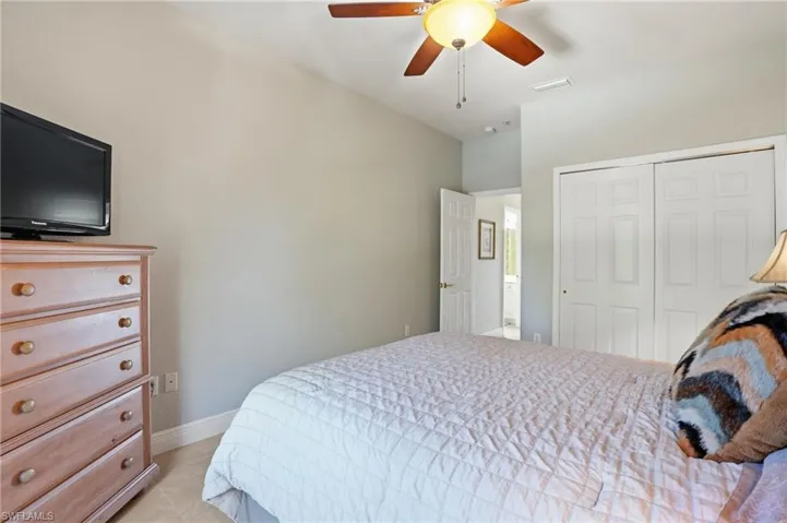 Bedroom with a ceiling fan and a closet