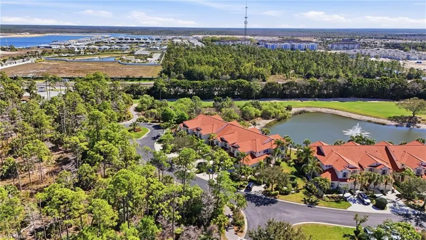 Aerial view of residential area featuring a large body of water and a golf course