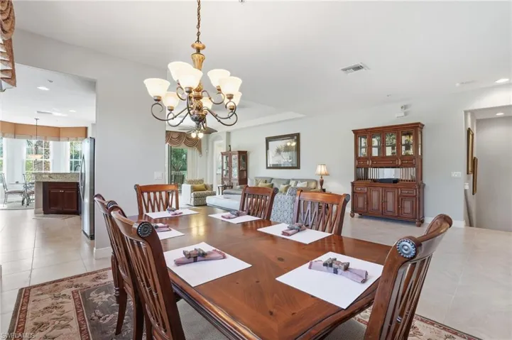 Dining space featuring light tile patterned floors and a chandelier