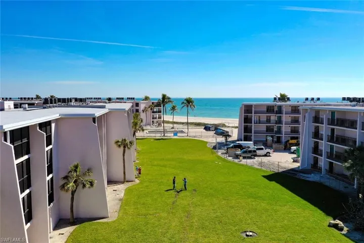 VIEW FROM PORCH OF POOL AND BEACH