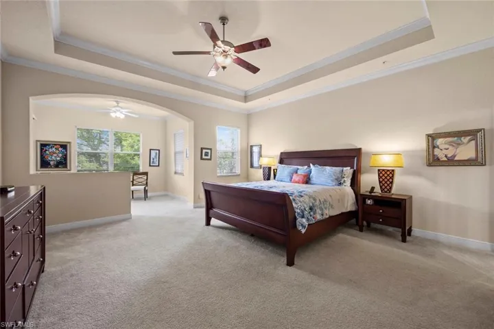 Primary bedroom with seating area that opens to lanai