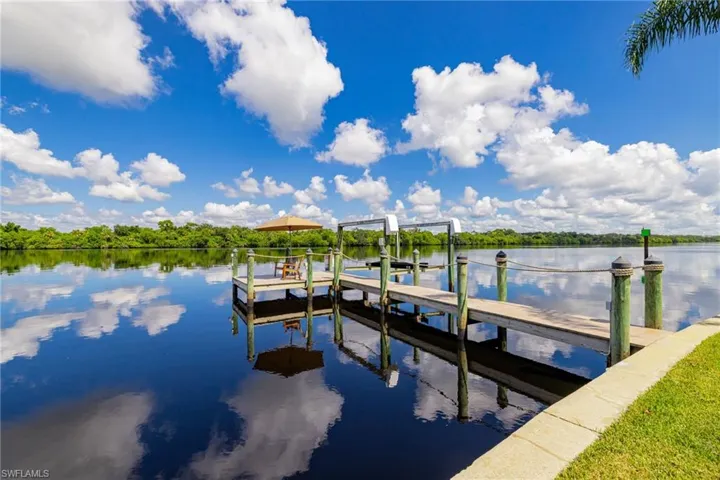 Dock featuring a river view and boat lift