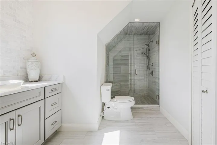 Bathroom with vanity and a stall shower