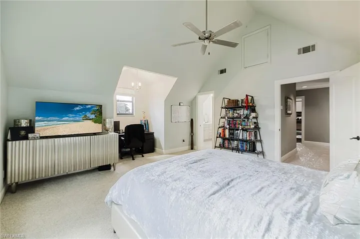 Bedroom featuring a desk, high vaulted ceiling, light colored carpet, ceiling fan
