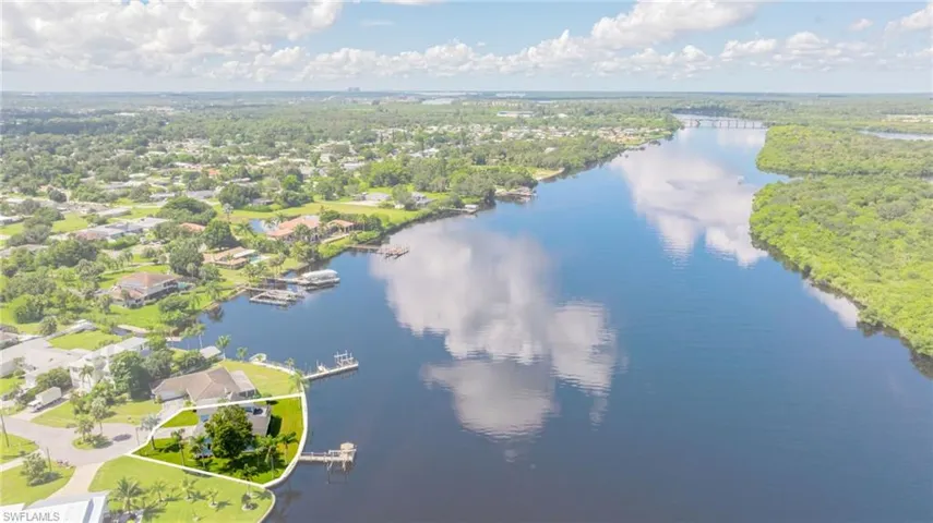 Aerial view of property's location on river and property boundaries highlighted
