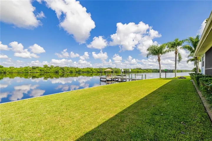Dock with a river view, a yard, and boat lift