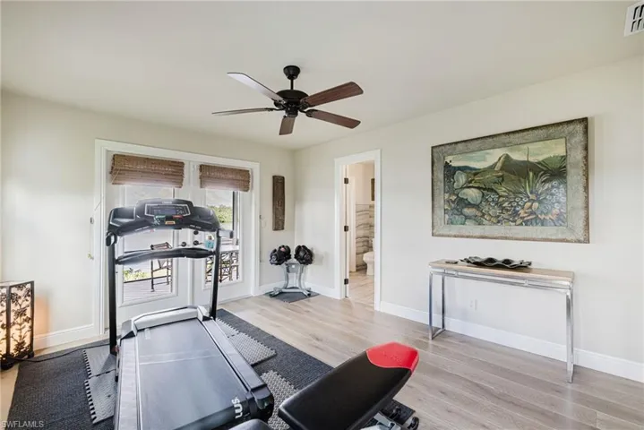 Bedroom with light wood flooring and ceiling fan