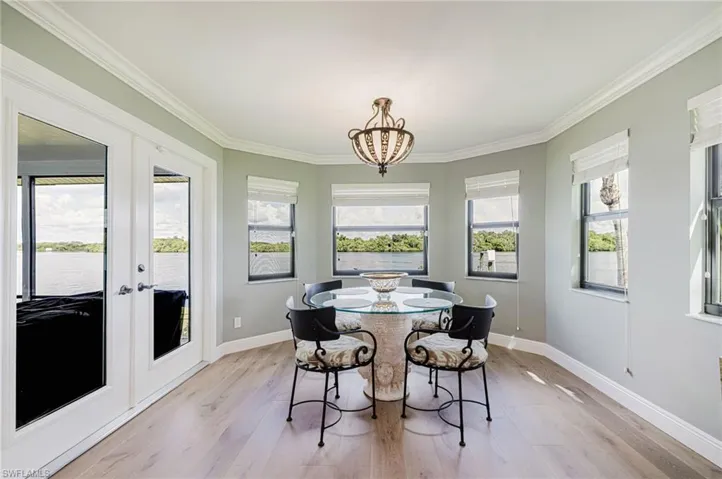 Dining areafeaturing french doors and a chandelier