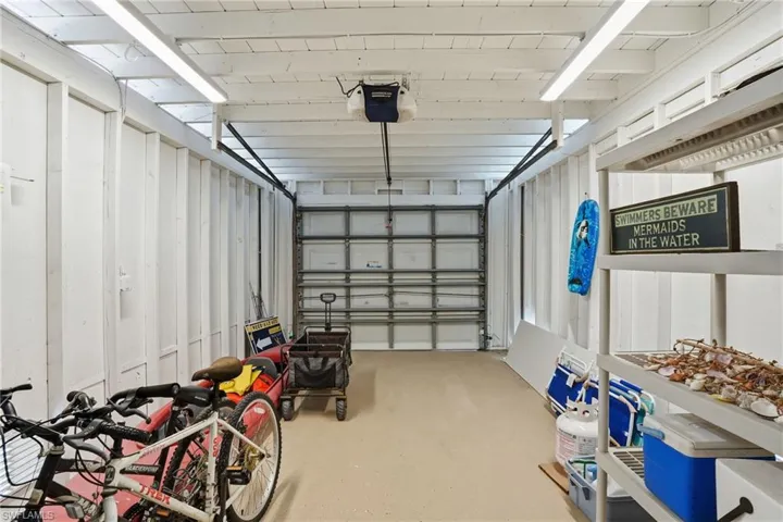 Garage featuring a garage door opener - Virtually Edited Image