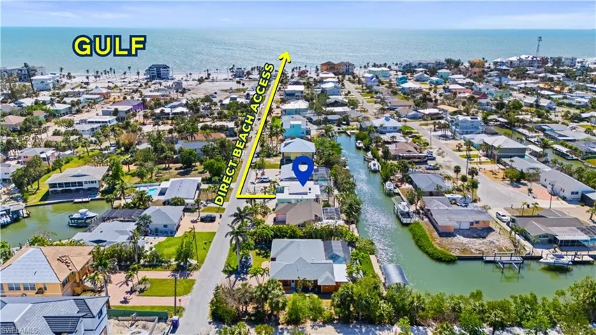 Aerial overview of property's location featuring a large body of water and nearby suburban area -  Virtually Edited Image