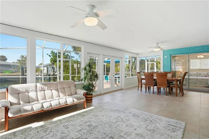 Sunroom with french doors and tile patterned floors - Virtually Edited Image