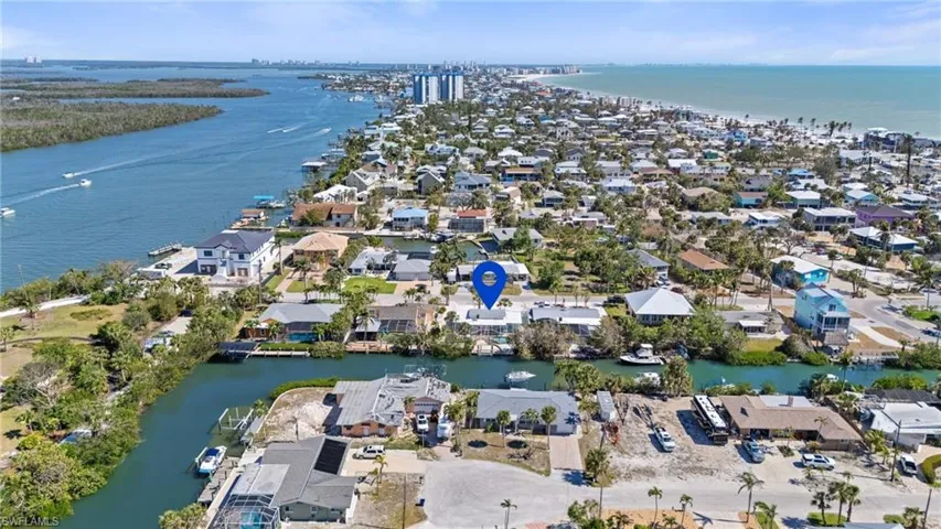 View of property location featuring a large body of water and nearby suburban area -  Virtually Edited Image