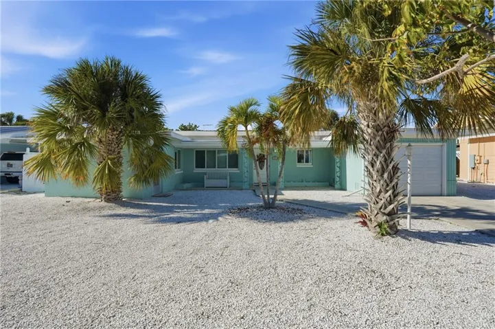 View of front of home with concrete driveway and an attached garage - Virtually Edited Image