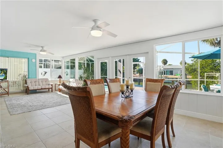 Sunroom featuring french doors and tile patterned flooring - Virtually Edited Image