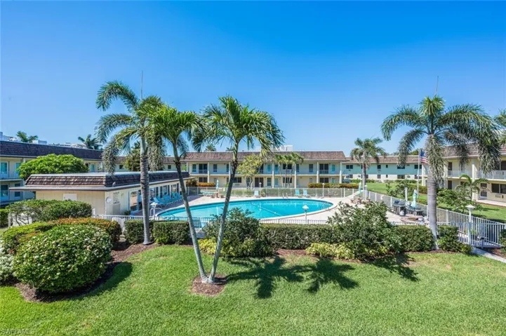 Pool featuring a lawn and fence