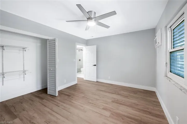 Unfurnished bedroom featuring baseboards, a ceiling fan, and wood finished floors