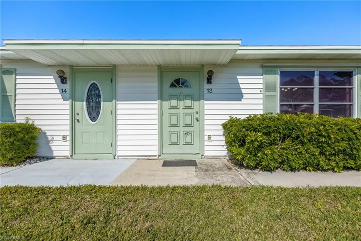 Doorway to property with a yard