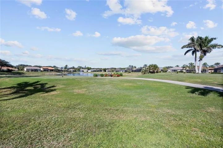 View of home's community featuring a water view and a yard
