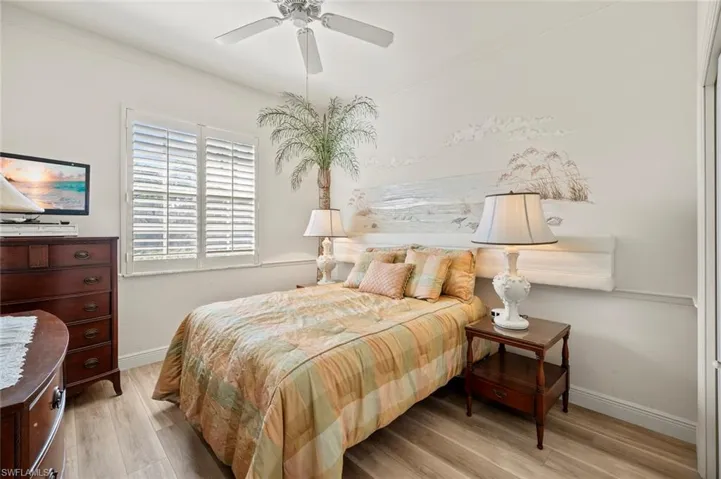 Bedroom with ceiling fan and light wood-type flooring