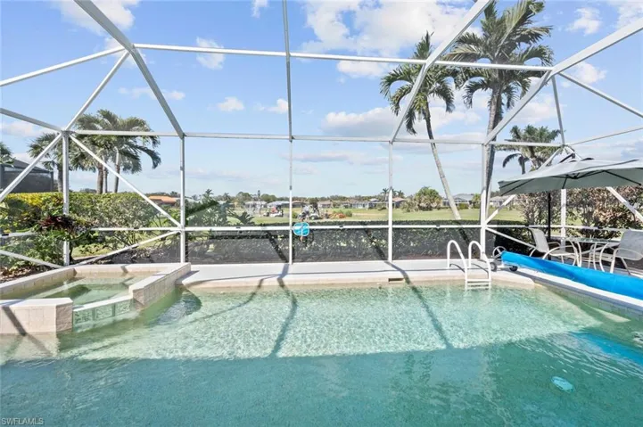 View of pool featuring an in ground hot tub, a water view, and a lanai
