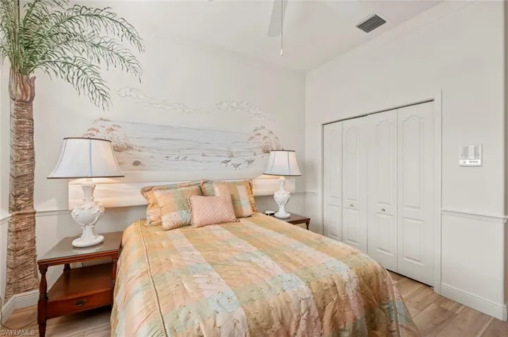 Bedroom with ornamental molding, a closet, and light wood-type flooring