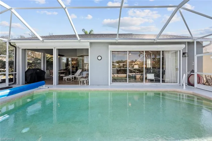 View of pool featuring area for grilling, a lanai, and a patio area