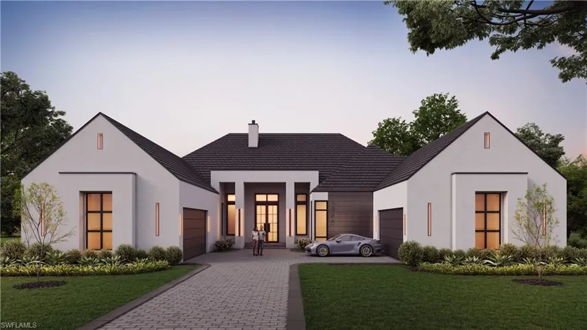 View of front facade featuring a lawn, a garage, decorative driveway, and stucco siding