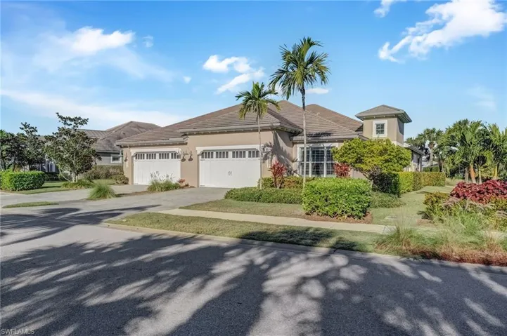 View of front of home with stucco siding, driveway, and a garage