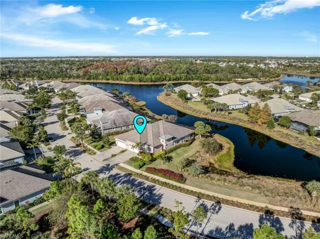 Aerial view of residential area featuring a nearby body of water