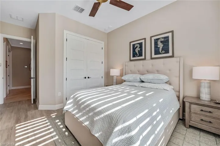 Bedroom featuring a closet, light wood-style flooring, and a ceiling fan