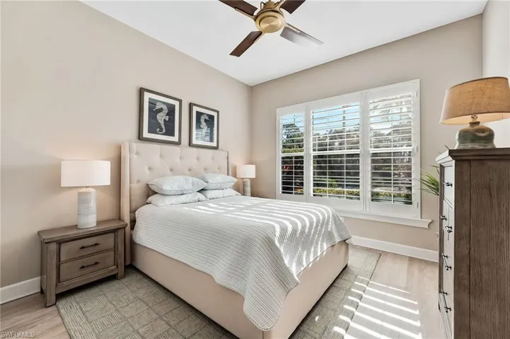 Bedroom with a ceiling fan and light wood-style flooring