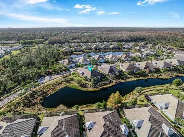 Aerial overview of property's location featuring a large body of water and nearby suburban area