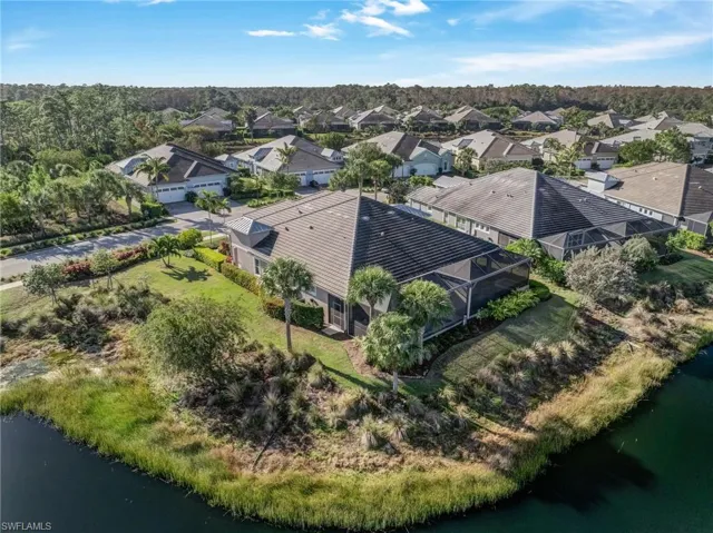 Aerial perspective of suburban area featuring a large body of water