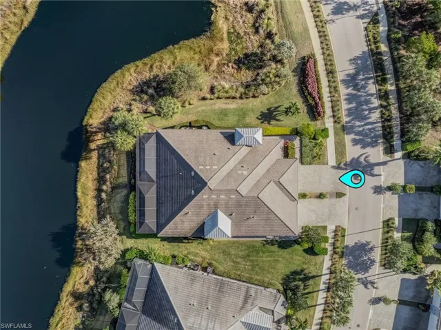 Aerial view of property's location featuring a large body of water