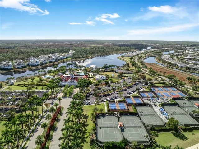 Aerial view of residential area featuring a nearby body of water