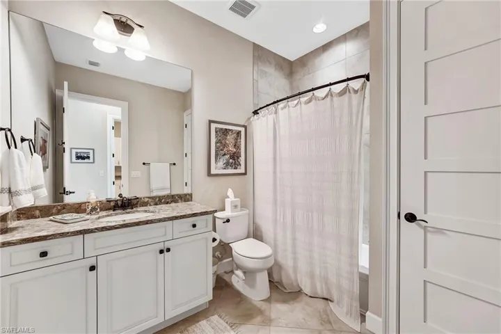 Bathroom with vanity and light tile patterned floors
