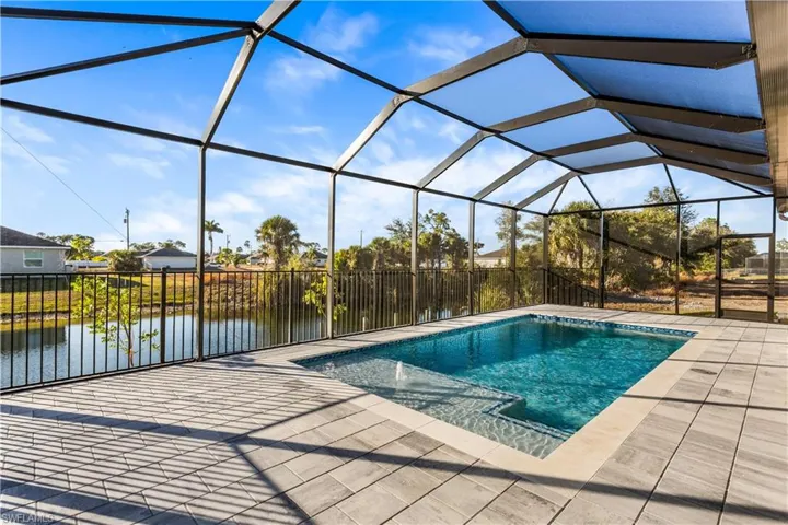 The primary suite offers lanai access, his-and-her walk-in closets, and a spa-style bath with dual sinks, soaking tub, and walk-in shower.
